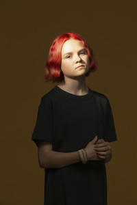 Portrait confident serious teenage girl with dyed red hair