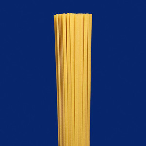 Close up uncooked spaghetti pasta on blue background