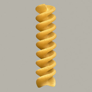 Close up uncooked fusilli bucati pasta noodle on gray background