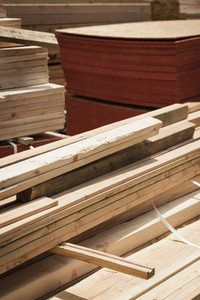 Stacks of wood planks and plywood at lumberyard