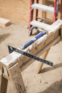 Hammer and carpenter square ruler at construction site