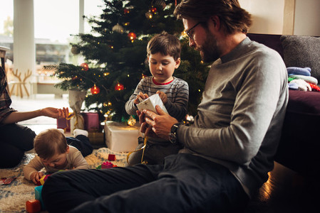 Father and son opening Christmas gifts