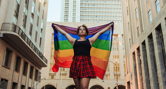 Lesbian woman flying the rainbow flag