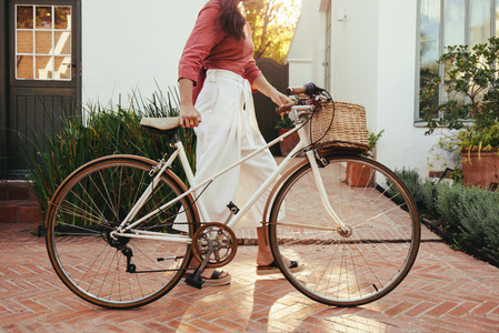 Young woman pushing a bike outdoors