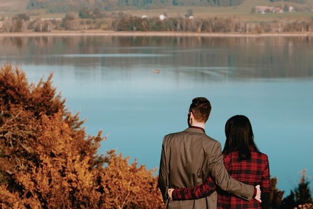 Couple standing by a lake 2