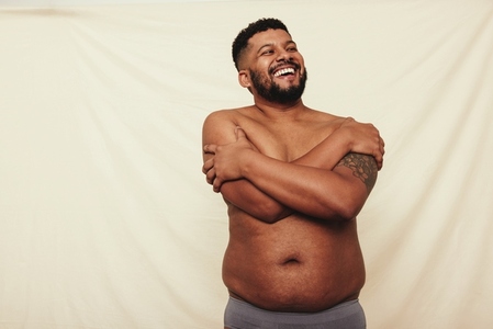 Man with pot belly embracing his natural body