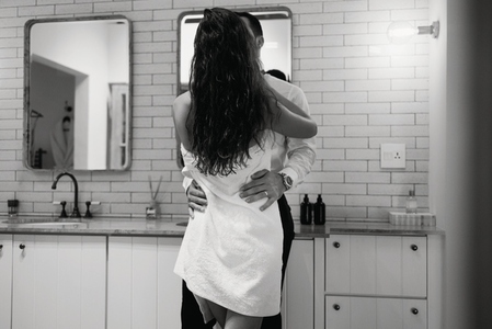 Black and white of a couple getting dressed together