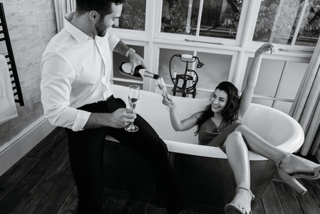 Lovely young couple celebrating with sparkling wine