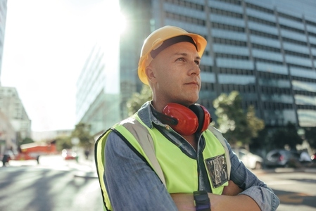 Construction worker looking away thoughtfully