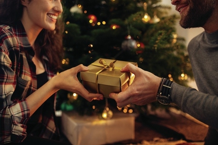 Couple celebrating Christmas together with gifts