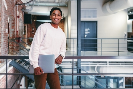 Happy young businessman smiling in a modern office