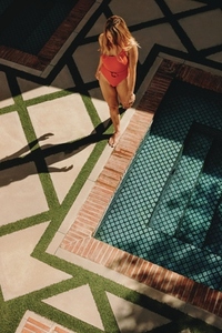 Top view of a tourist woman going for a swim in red swimwear