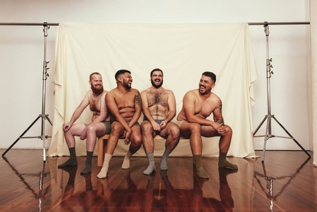Happy men wearing underwear in a studio