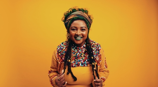 Happy young woman wearing African clothing