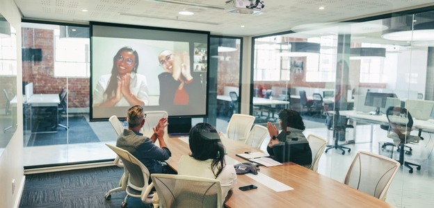 Global businesspeople clapping during a video conference