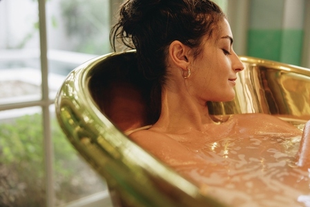 Serene young woman enjoying a relaxing bath
