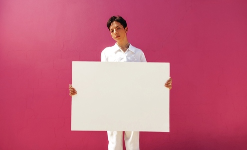 Teenage gay activist displaying a blank banner in a studio