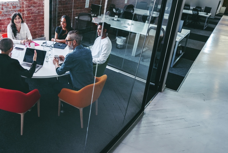 Female supervisor briefing her team in an office