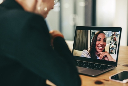 Happy businesswoman attending a video conference in an office