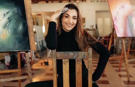 Successful female painter smiling at the camera