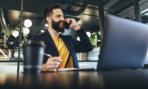 Happy businessman smiling during a phone call