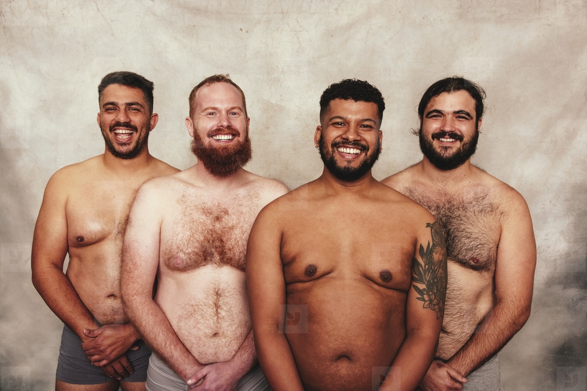 Portrait of shirtless men smiling cheerfully