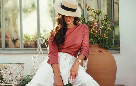 Fashionable young woman with a tipped summer hat