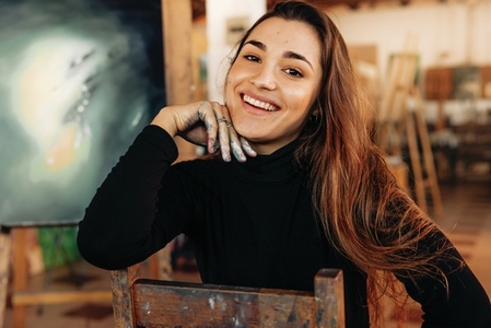 Happy professional painter smiling at the camera