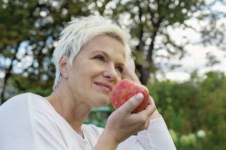 Woman eating fresh red apple