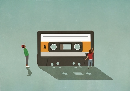 Boy and girl looking at cassette tape