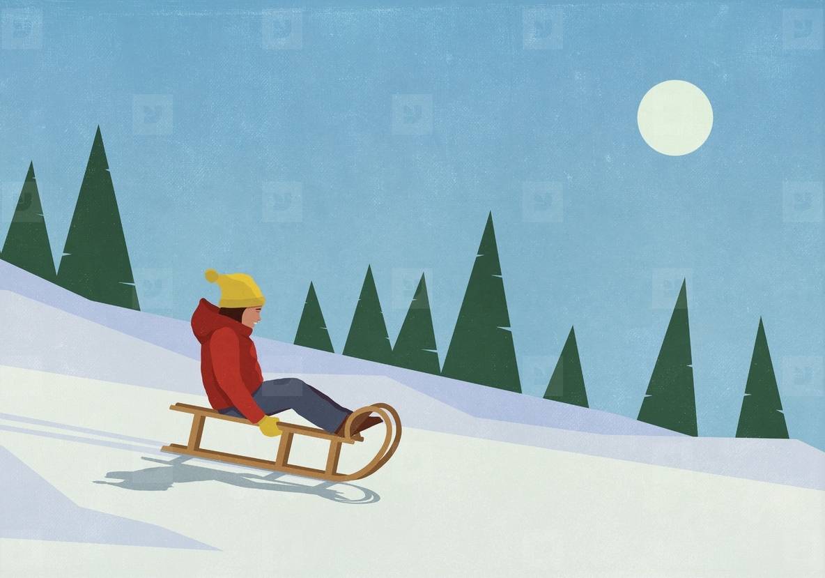 Carefree woman sledding on snowy slope