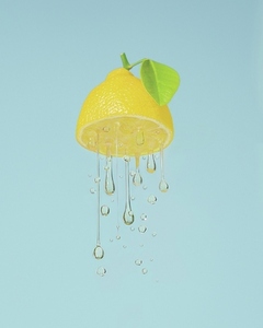 Juicy yellow lemon dripping against blue background