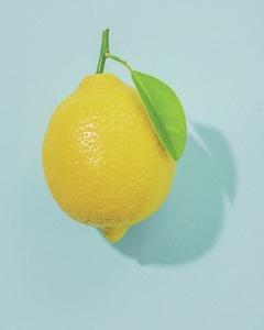 Bright yellow lemon on blue background