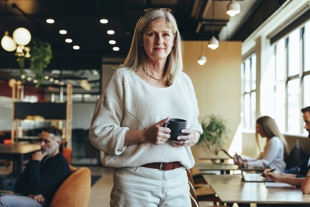 Mature businesswoman standing in a co working space