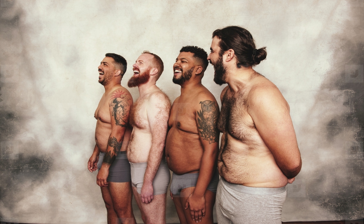 Group of men laughing cheerfully in underwear