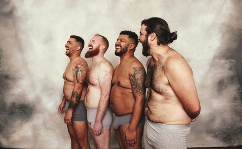 Group of men laughing cheerfully in underwear