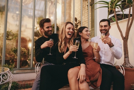 Couples raising their champagne glasses at a retreat