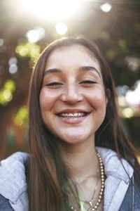 Adorable teenage girl with braces smiling cheerfully