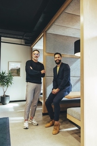 Two businessmen looking at the camera in an office