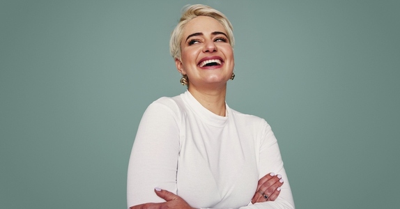 Beautiful blonde woman laughing in a studio
