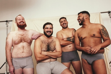 Cheerful laughter among body positive men