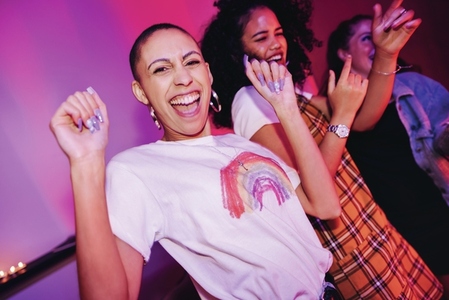 Young woman dancing with her friends at a party