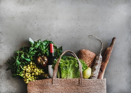 Flat lay of healthy grocery shopping bag with food and wine