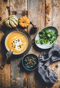 Flat lay of autumn warming pumpkin soup in bowl