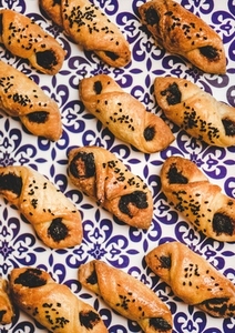 Turkish salty pastry with black olive paste filling in rows