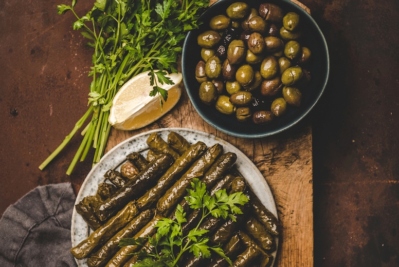 Flat-lay of traditional turkish Dolma meze or snack on board