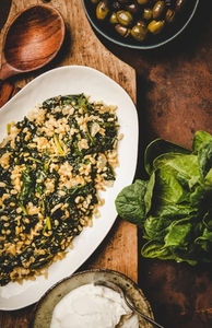Flat lay of Turkish traditional dish Bulgur and spinach on board
