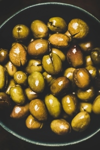 Flat lay of fresh harvested pickled Mediterranean olives  close up