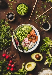 Salmon poke bowl or sushi bowl with vegetables and greens