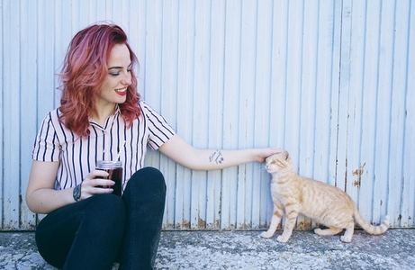 Young redhead woman and cat